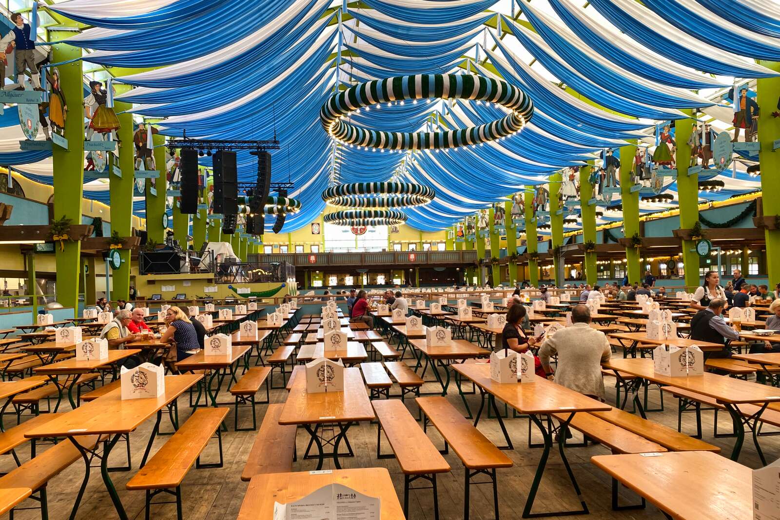 People enjoying an early day at a tent at the Oktoberfest grounds in Munich, Germany.