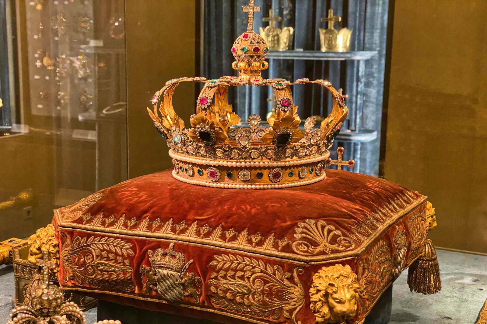 An ornately decorated crown in the Nymphenburg Palace exhibits.