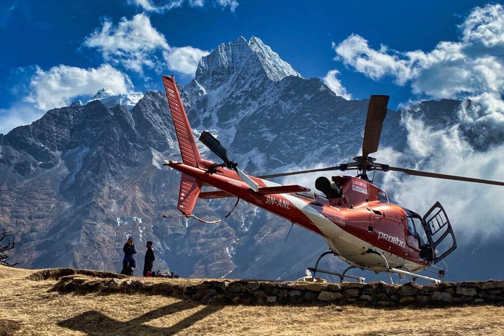 People waiting to board a helicopter on Syangboche Hill in Nepal.