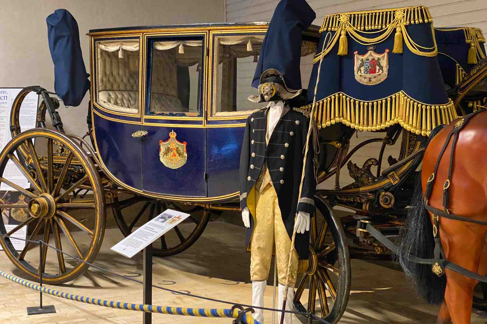 A horse-drawn carriage on display at the Royal Armory in Stockholm, Sweden.