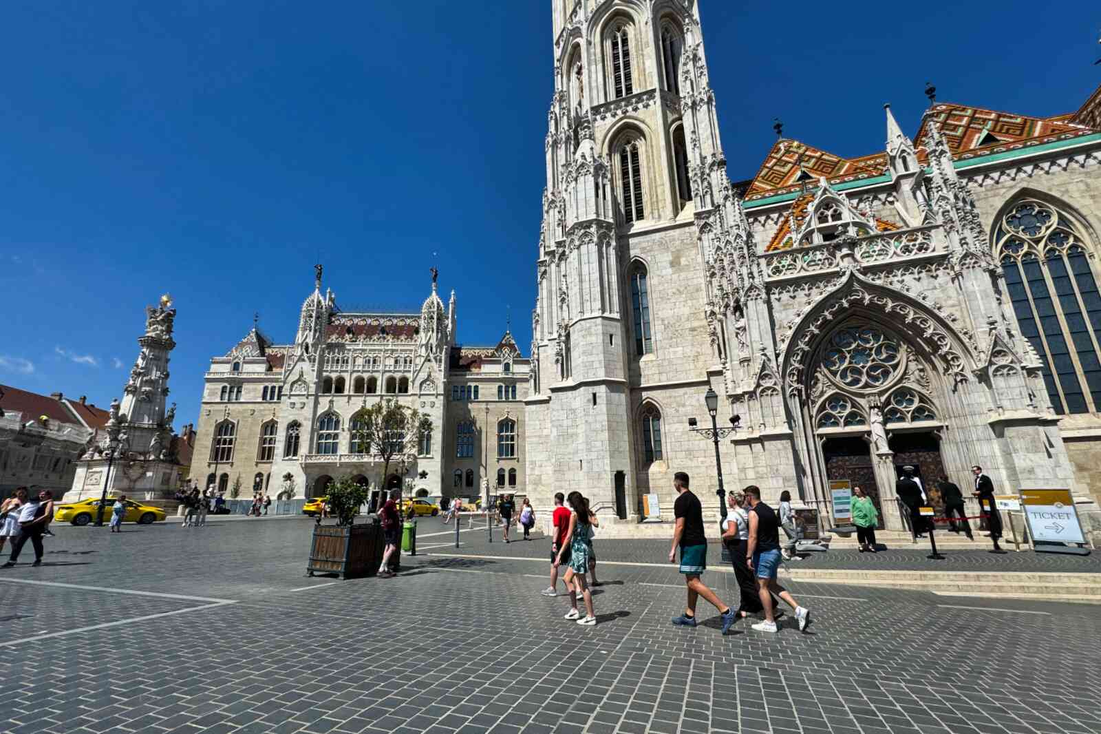 People walking past Matthias Church in Budapest, Hungary.