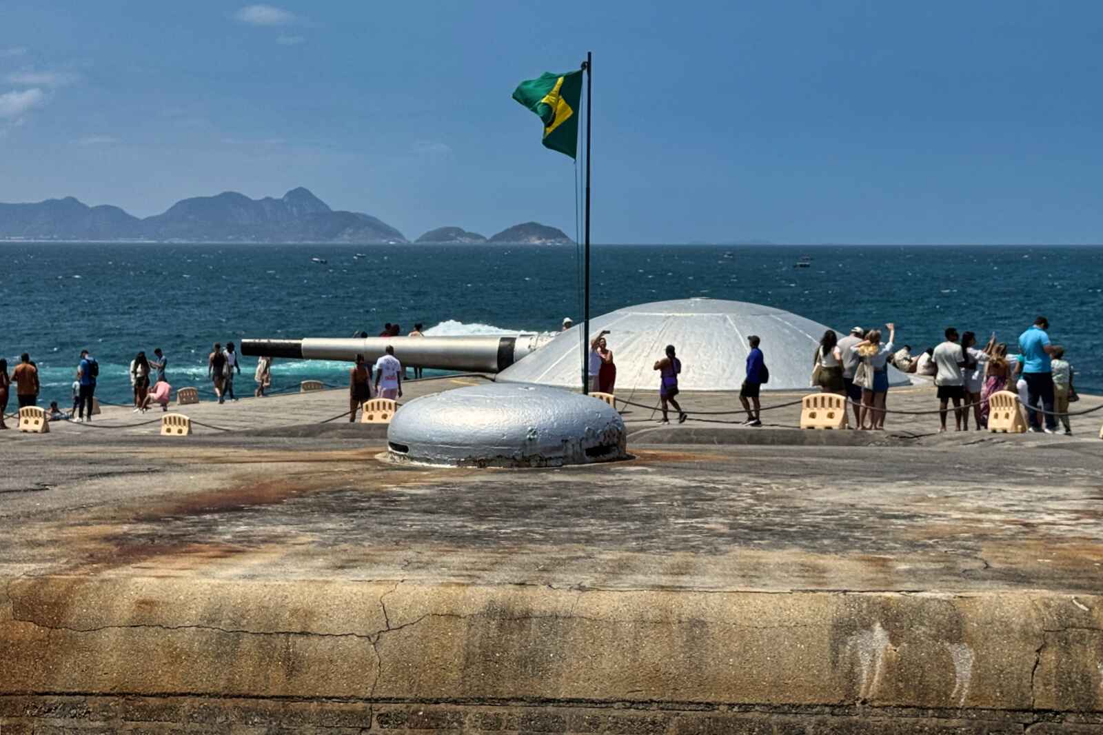 People photographing the decommissioned artillery at Fort Copacabana in Rio de Janeiro.