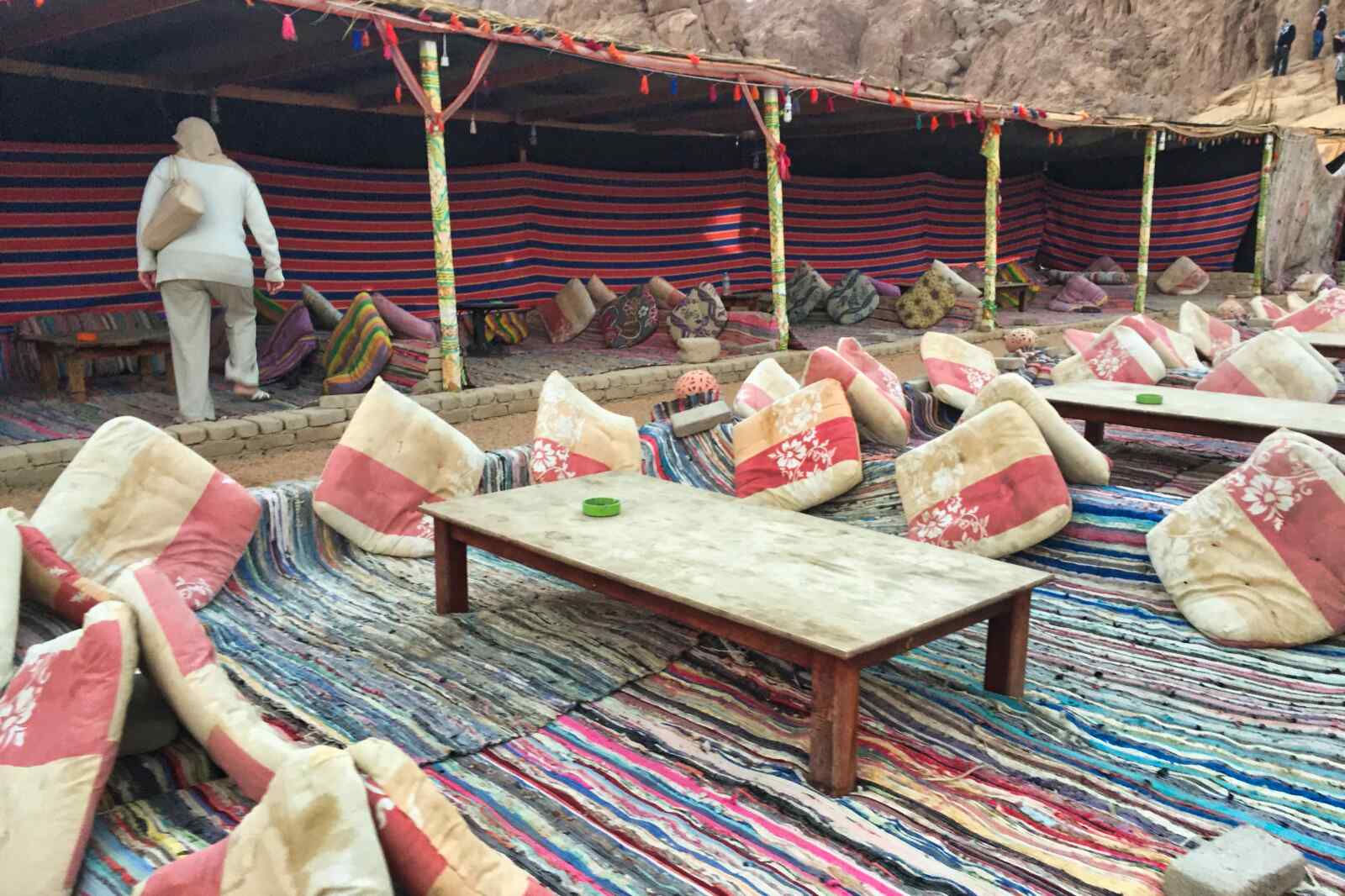 A woman is finding a seat at a bedouin encampment near Sharm El-Sheikh, Egypt.