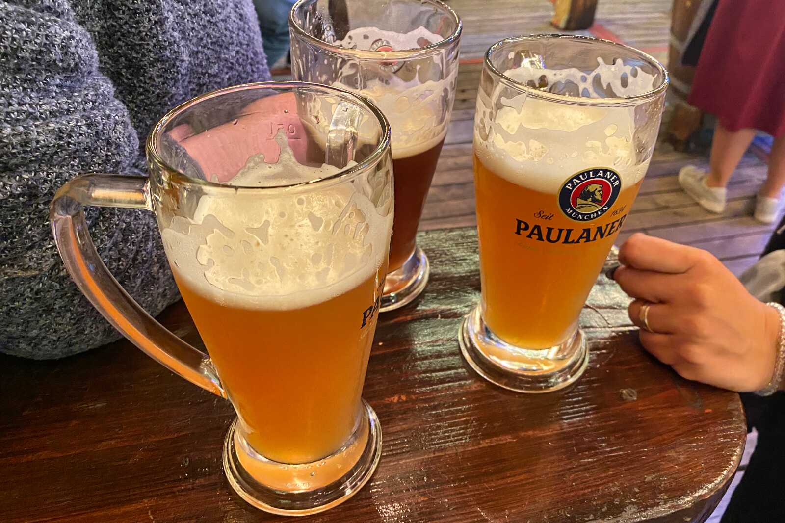 People enjoying a Paulaner beer at Oktoberfest.