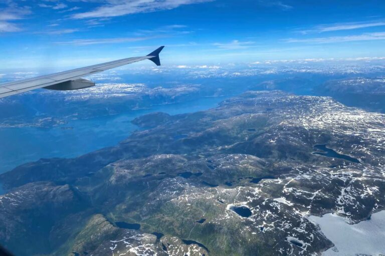 View from the window seat of a plane overlooking Norway.