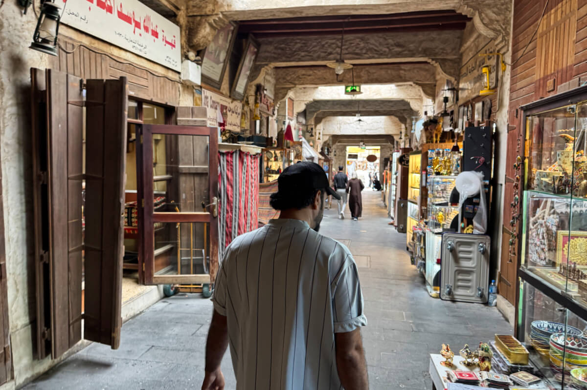 A man walks through the corridors of Souq Waqif in Doha, Qatar.